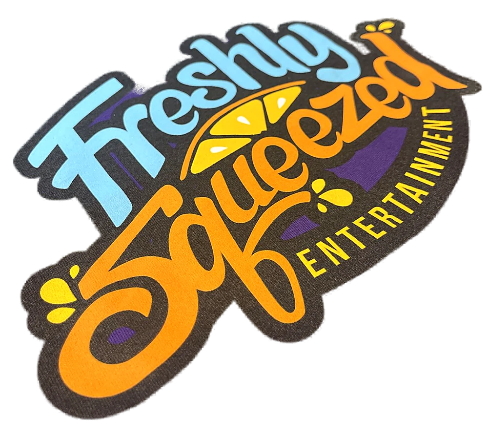Multi-colour screen printed Freshly Squeezed Entertainment logo on a purple t-shirt